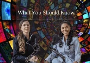 Two women sitting in front of microphones with a stained glass background.